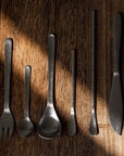 Japanese Retro Stainless Steel Cutlery Set on wooden surface, featuring six essential pieces with brushed finish.