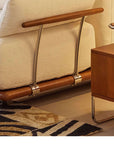 Luxurious Nozomi Banca Sofa with LoveÉcru fabric, showcasing wooden and metal details, next to a wood side table.