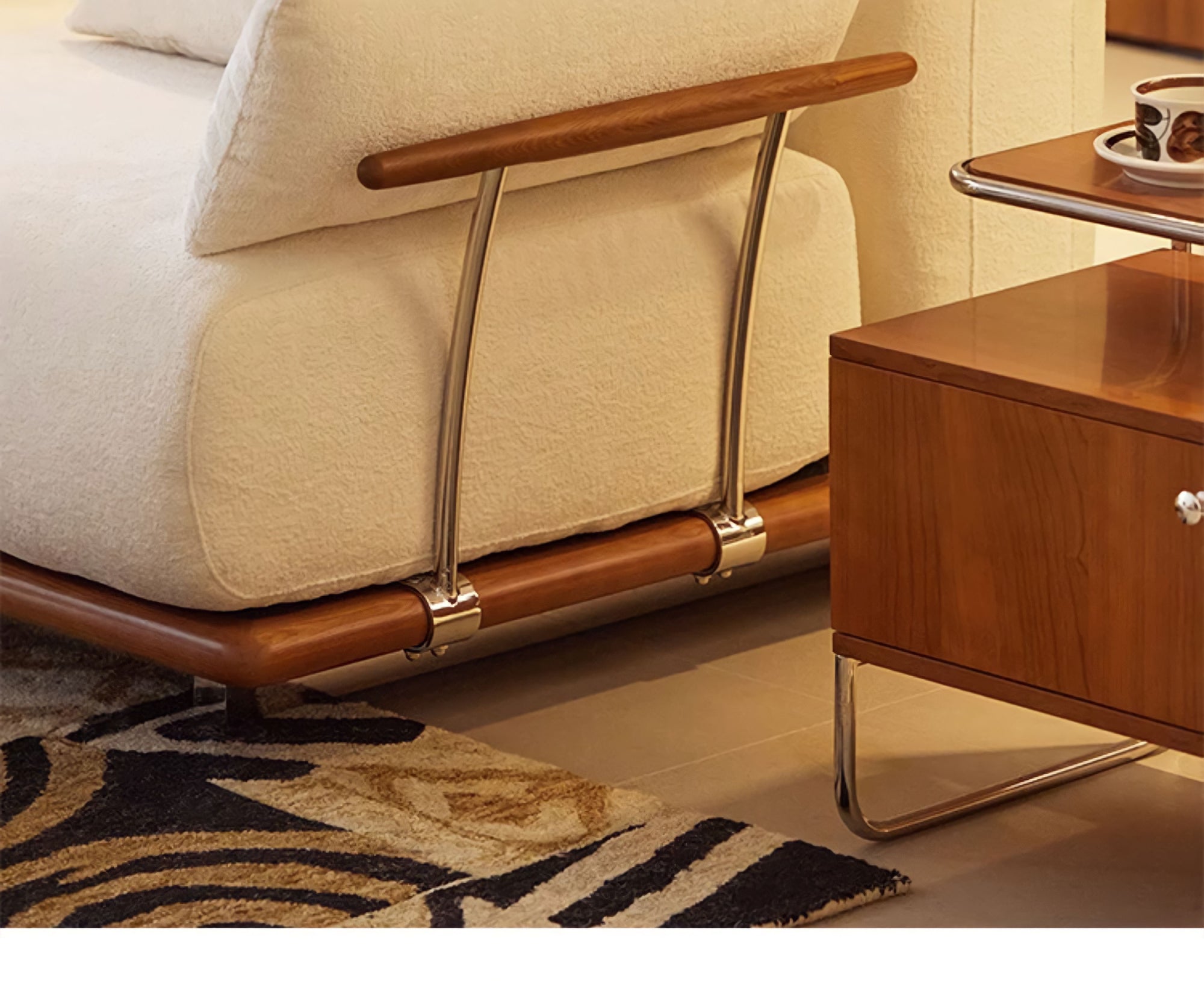 Luxurious Nozomi Banca Sofa with LoveÉcru fabric, showcasing wooden and metal details, next to a wood side table.