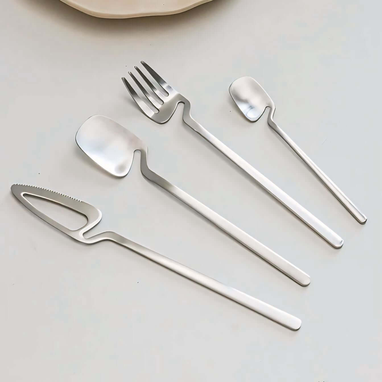 Minimalist Stainless Steel Flatware Set with knife, fork, spoon, showcased on a light background, highlighting modern Scandinavian design.