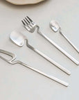 Minimalist Stainless Steel Flatware Set with knife, fork, spoon, showcased on a light background, highlighting modern Scandinavian design.