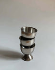 Stack of three stainless steel egg holders with matte finish, showcasing durable and stylish design for kitchen decor.