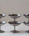 Elegant stainless steel dessert cups set on a table, perfect for enhancing dining with sophistication and versatile use.