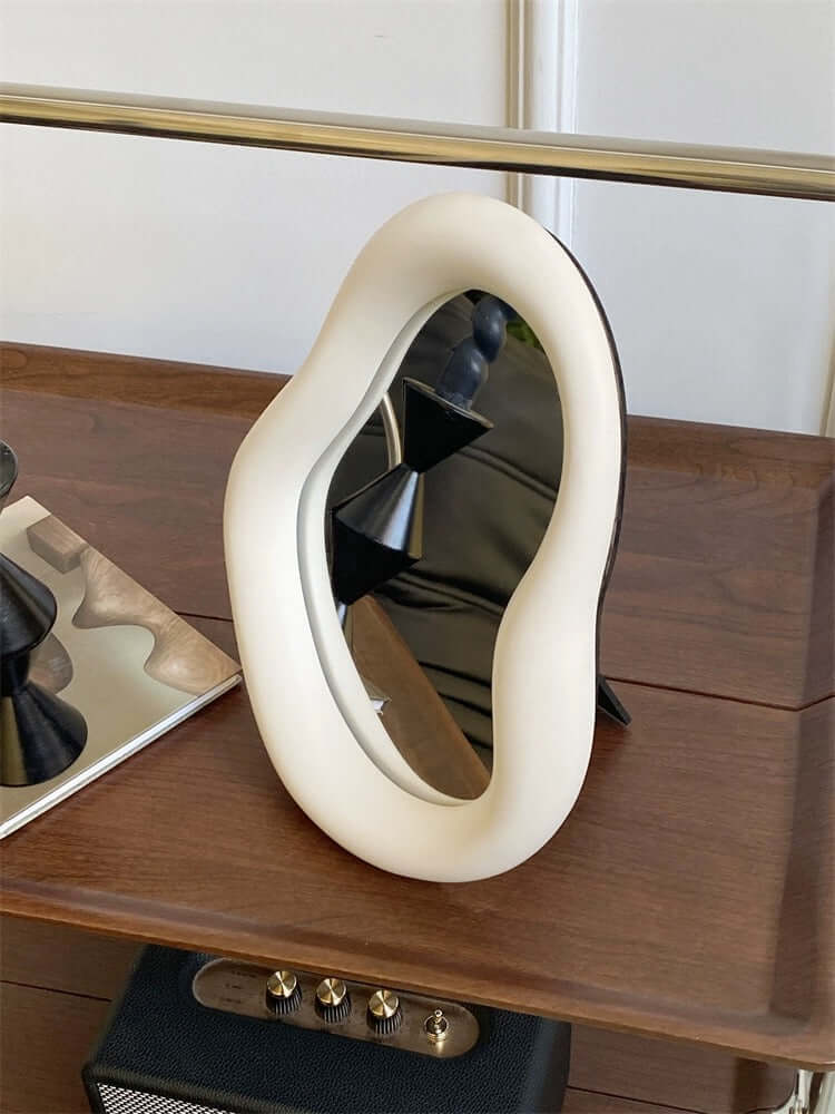 Nordic asymmetric cream mirror, 29x22 inches, on wooden surface. Stylish home decor with free shipping.
