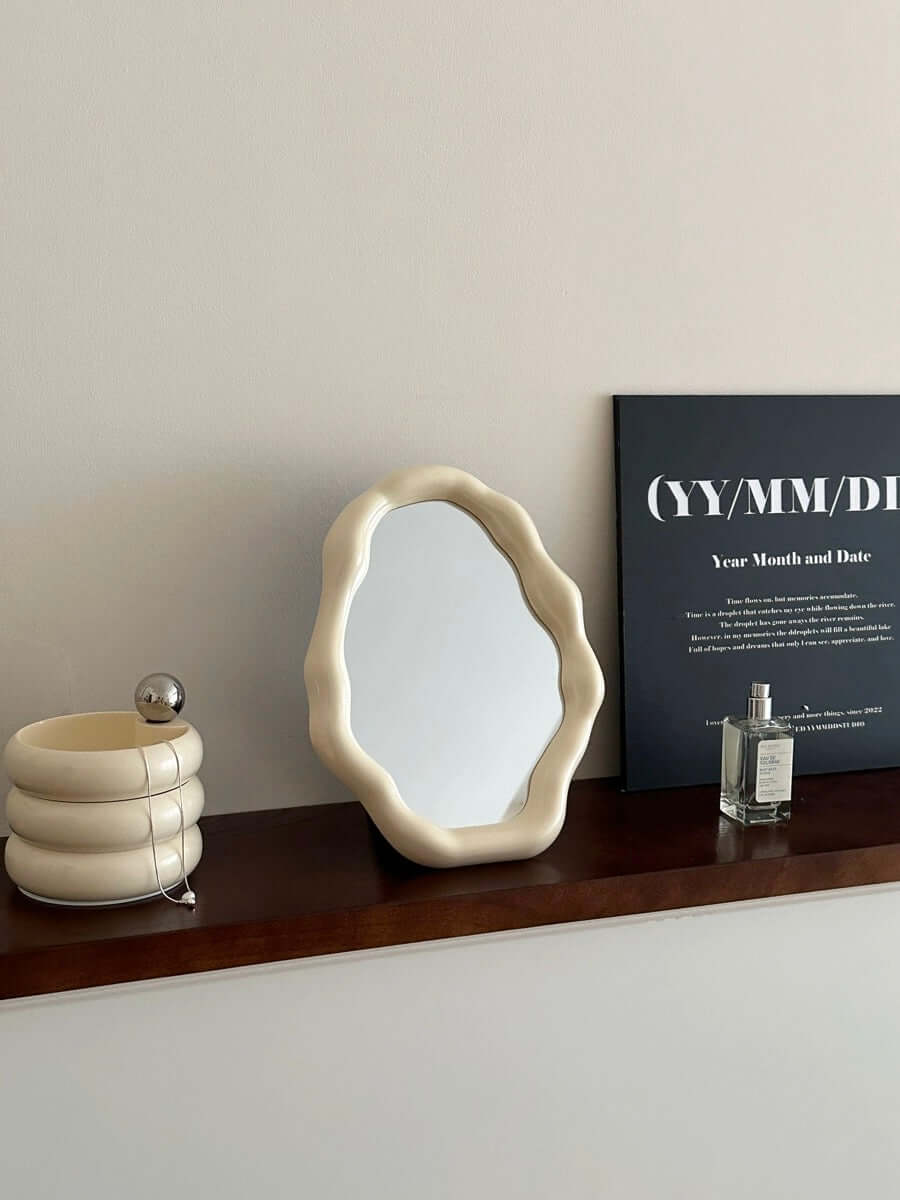 Nordic cloud-shaped vanity mirror on wooden shelf, surrounded by decor, perfect for modern interior design. Size: 27x20cm, free shipping.