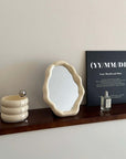 Nordic cloud-shaped vanity mirror on wooden shelf, surrounded by decor, perfect for modern interior design. Size: 27x20cm, free shipping.