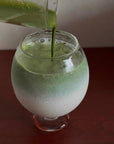 Pouring matcha into the Lumi Stem Glass