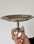 Elegant Dessert Pedestal Stand, classic edge, held up in a hand