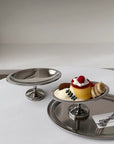 Elegant Dessert Pedestal Stand holding a pastry on a mirror tray