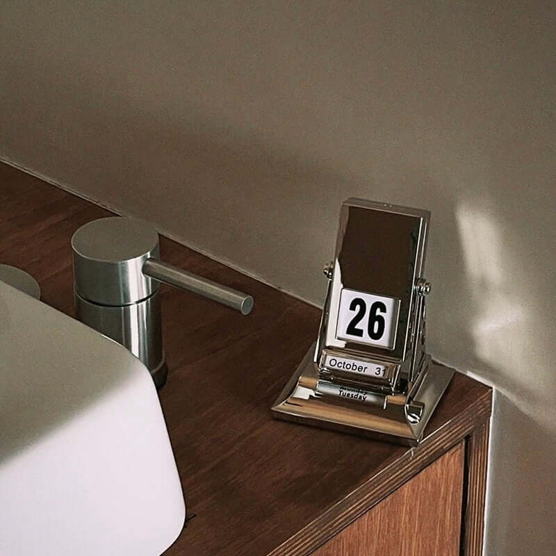 Elegant Nordic Rotating Desk Calendar with mechanical page-turning, set on wooden desk, displaying October 26 date.