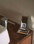 Elegant Nordic Rotating Desk Calendar with mechanical page-turning, set on wooden desk, displaying October 26 date.