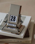 Timeless Rotating Desk Date Keeper on books, elegant and functional Nordic perpetual calendar with free shipping.