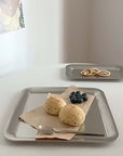 Urban Chic stainless steel serving tray with scones, blueberries, and a knife on a table. Minimalist design for elegant dining.