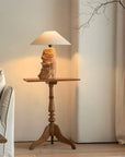 Custom-crafted wooden lamp on elegant side table in cozy living room setting.