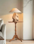Custom-crafted wooden lamp on vintage wooden table in cozy living room setting