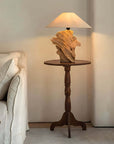 Custom-crafted wooden lamp on round table, illuminating cozy living space. Unique design available at Loveecru. Contact for inquiries.