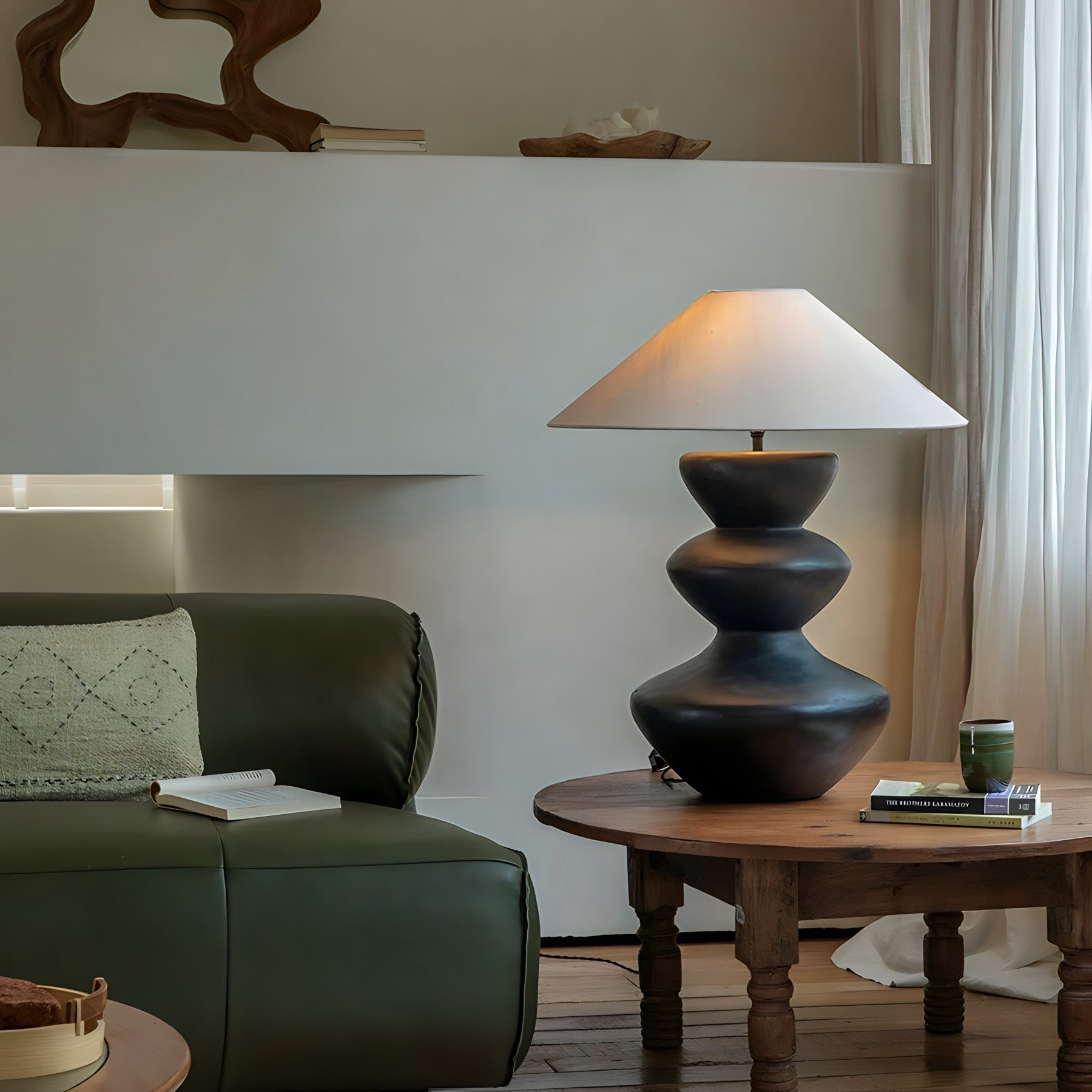 Stylish Hill Table Lamp with a linen shade and ceramic body on a wooden table in a cozy living room setting.