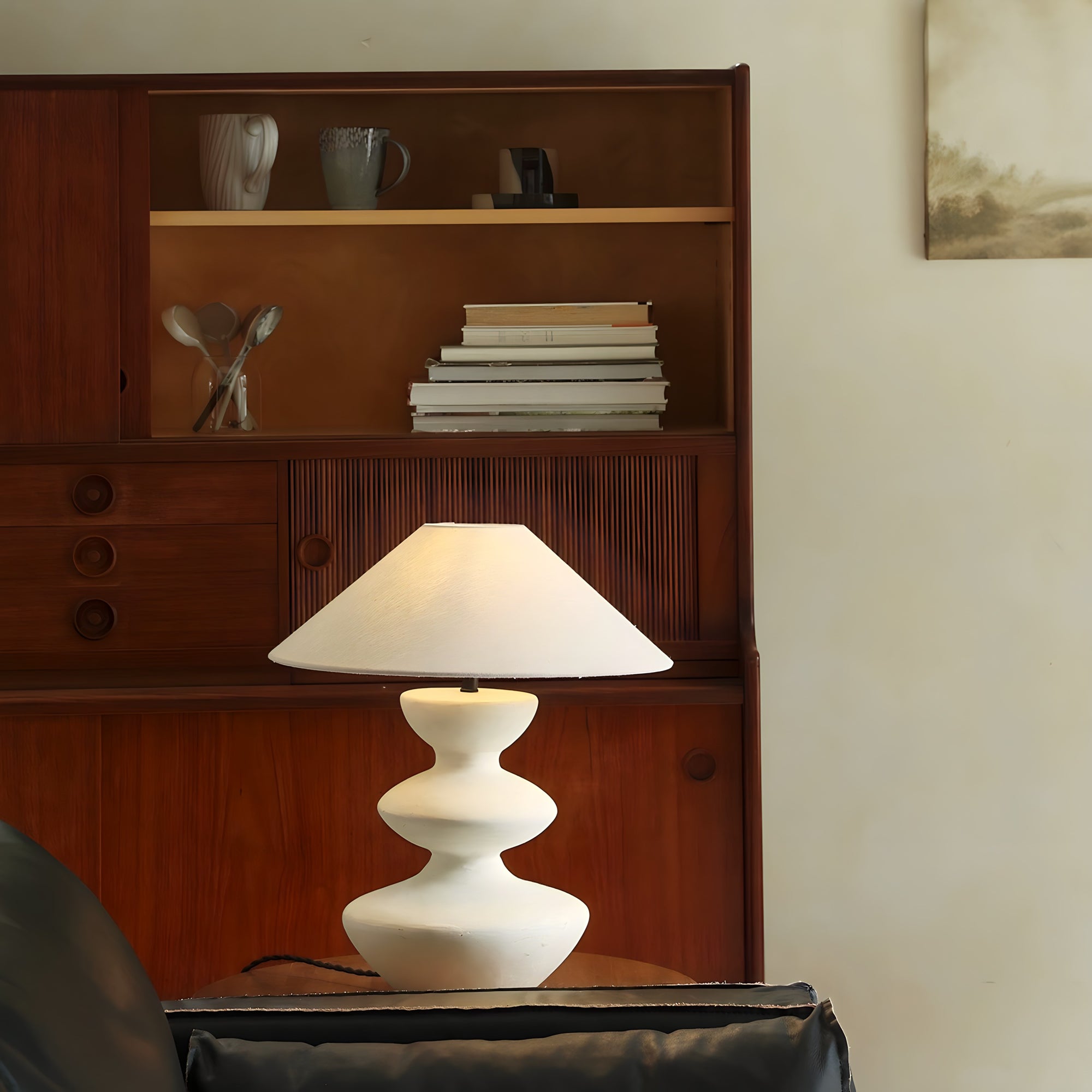 Hill Table Lamp with linen shade and ceramic base on table in cozy room ambiance.
