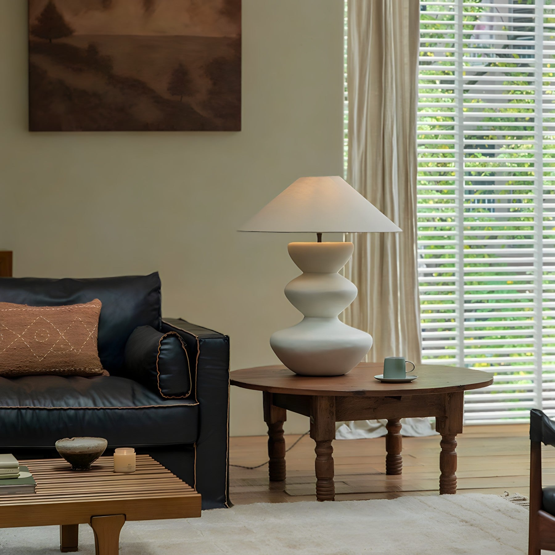 Elegant Hill Table Lamp with linen shade and ceramic body on a wooden table, enhancing the cozy living room decor.