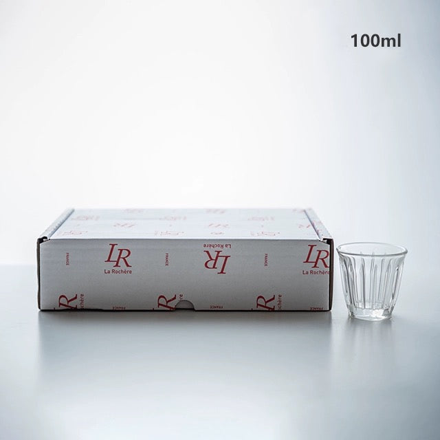 Zinc coffee glass cup with ridged design next to branded packaging, 100ml capacity, made in France.