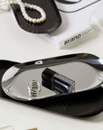Minimalist stainless steel tray with sleek design, ideal for display and serving, styled with jewelry and cosmetics.
