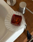 Lumière Shell Glass Dish with soap on the edge of a bath
