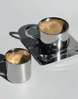 Venice Mirror Cup set with polished finish, featuring two elegant cups on a saucer with a spoon, perfect for a luxurious coffee experience.