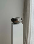 Kyoto Stainless Steel Bowls stacked on a white plinth by a window