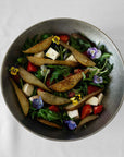 Kyoto Stainless Steel Bowl with a salad of roasted potatoes and edible flowers, top view