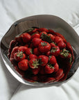 Sculpted Stainless Steel Bowl filled with strawberries, showing its flared rim