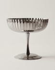 Fluted Dessert Coupe, mirror stainless steel, side view on a cream background