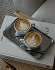 Minimalism Stainless Steel Serving Tray with two lattes on a stack of magazines