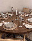 Dinner table set with Stainless Steel Champagne Flutes, plates and candles