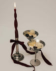 Stainless Steel Martini Glasses with a lit candle and a dark red ribbon