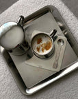 Luxurious stainless steel serving tray with elegant cups, showcasing an urban chic and minimalist design.