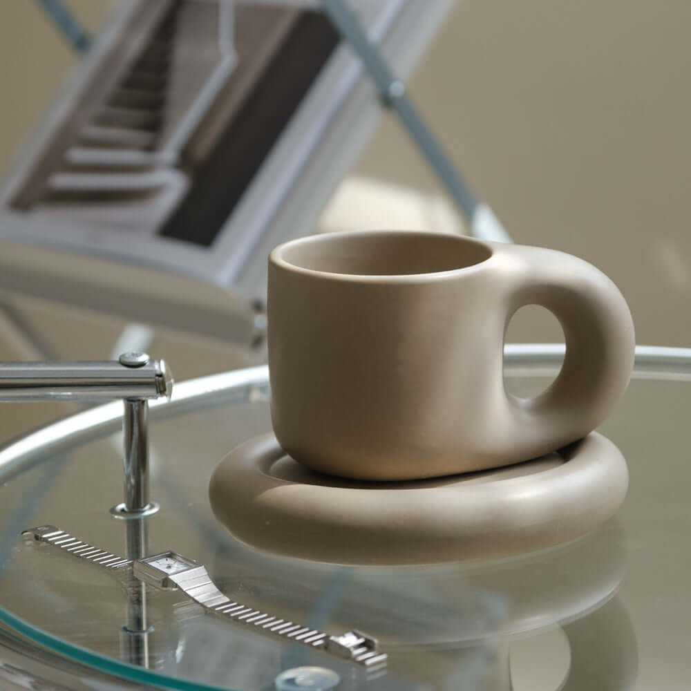 Artisan Nordic Chubby Mug & Plate on glass table, showcasing minimalist design and Nordic elegance.