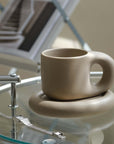 Artisan Nordic Chubby Mug & Plate on glass table, showcasing minimalist design and Nordic elegance.