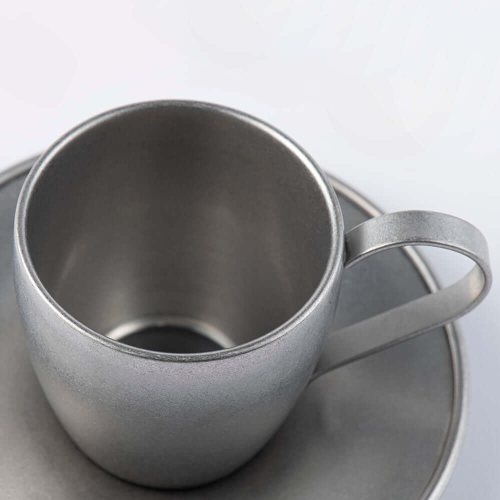 Vintage INOX stainless steel cup and saucer set, close-up view, elegant design, made in Japan, durable and dishwasher safe.