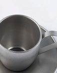 Vintage INOX stainless steel cup and saucer set, close-up view, elegant design, made in Japan, durable and dishwasher safe.