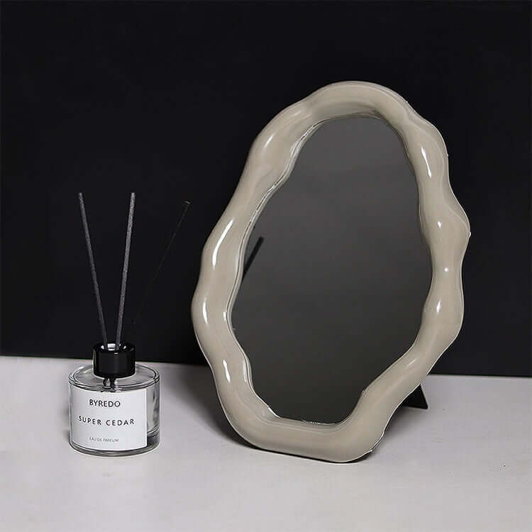 Nordic cloud-shaped vanity mirror with beige frame, alongside Byredo Super Cedar diffuser, size 27x20cm, free shipping.
