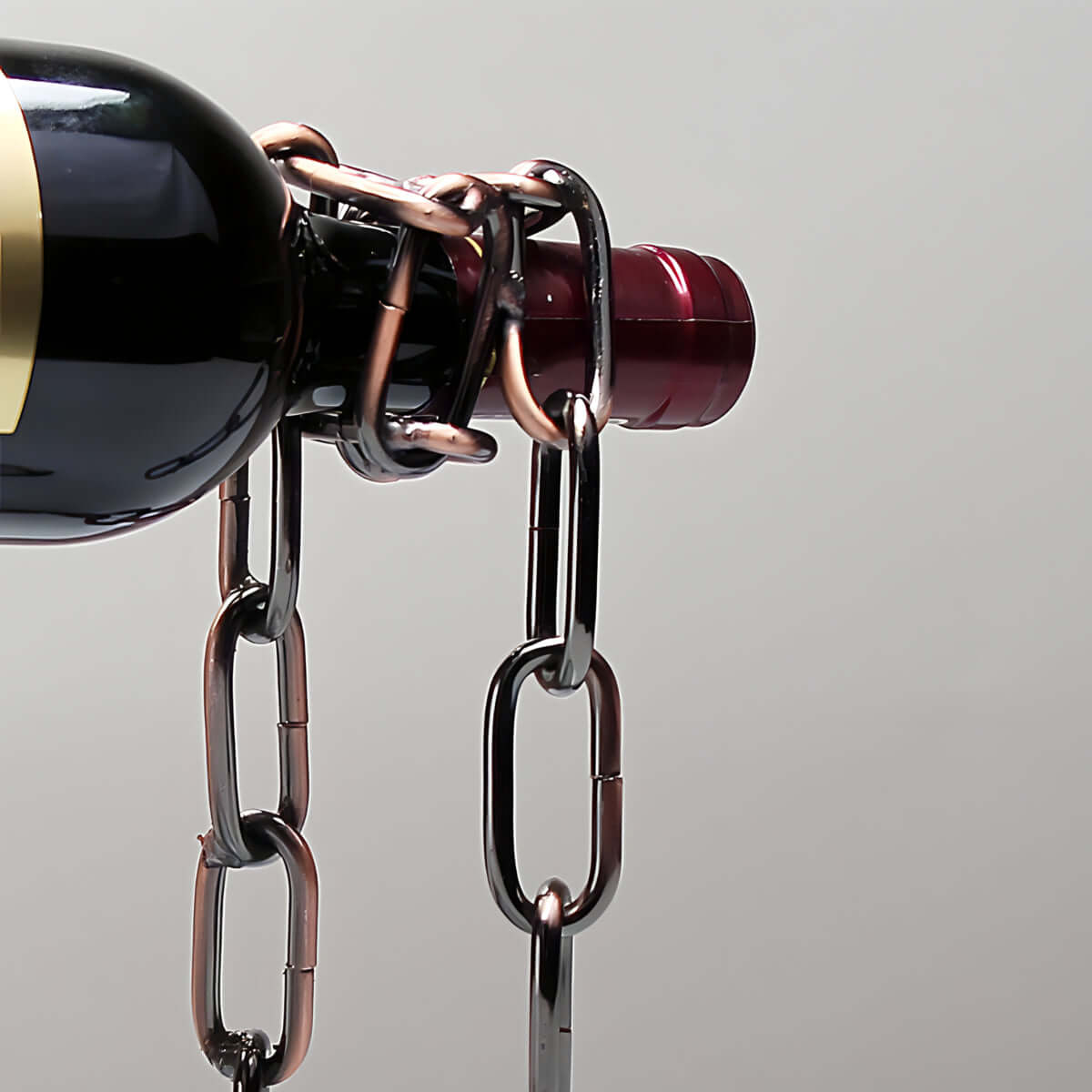 Unique chain wine bottle holder displaying a bottle, creating an illusion of suspension. Perfect for wine lovers and home decor.