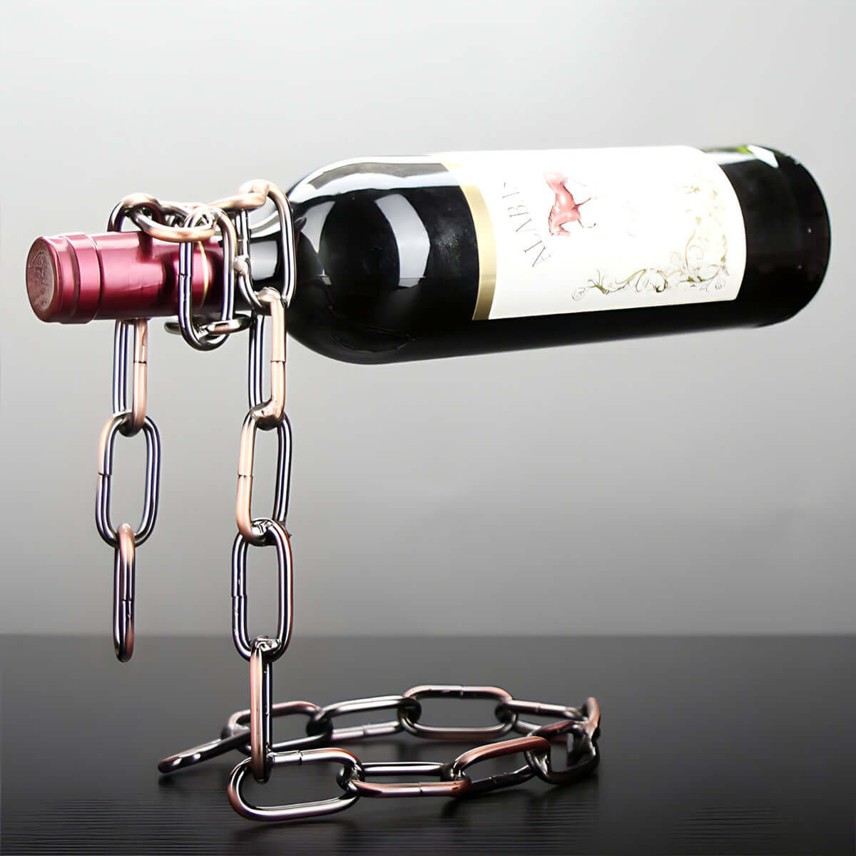 Chain wine bottle holder creating a floating illusion with a suspended wine bottle on display.