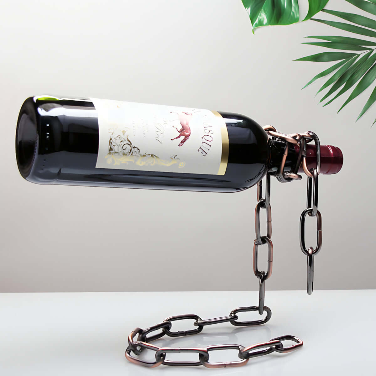 Chain wine bottle holder creatively suspends a wine bottle, adding a unique touch to home decor.