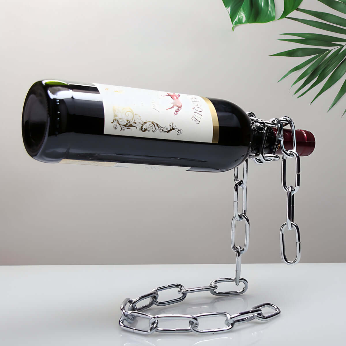 Chain wine bottle holder creating a floating illusion on tabletop.