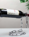 Chain wine bottle holder creating a floating illusion on tabletop.