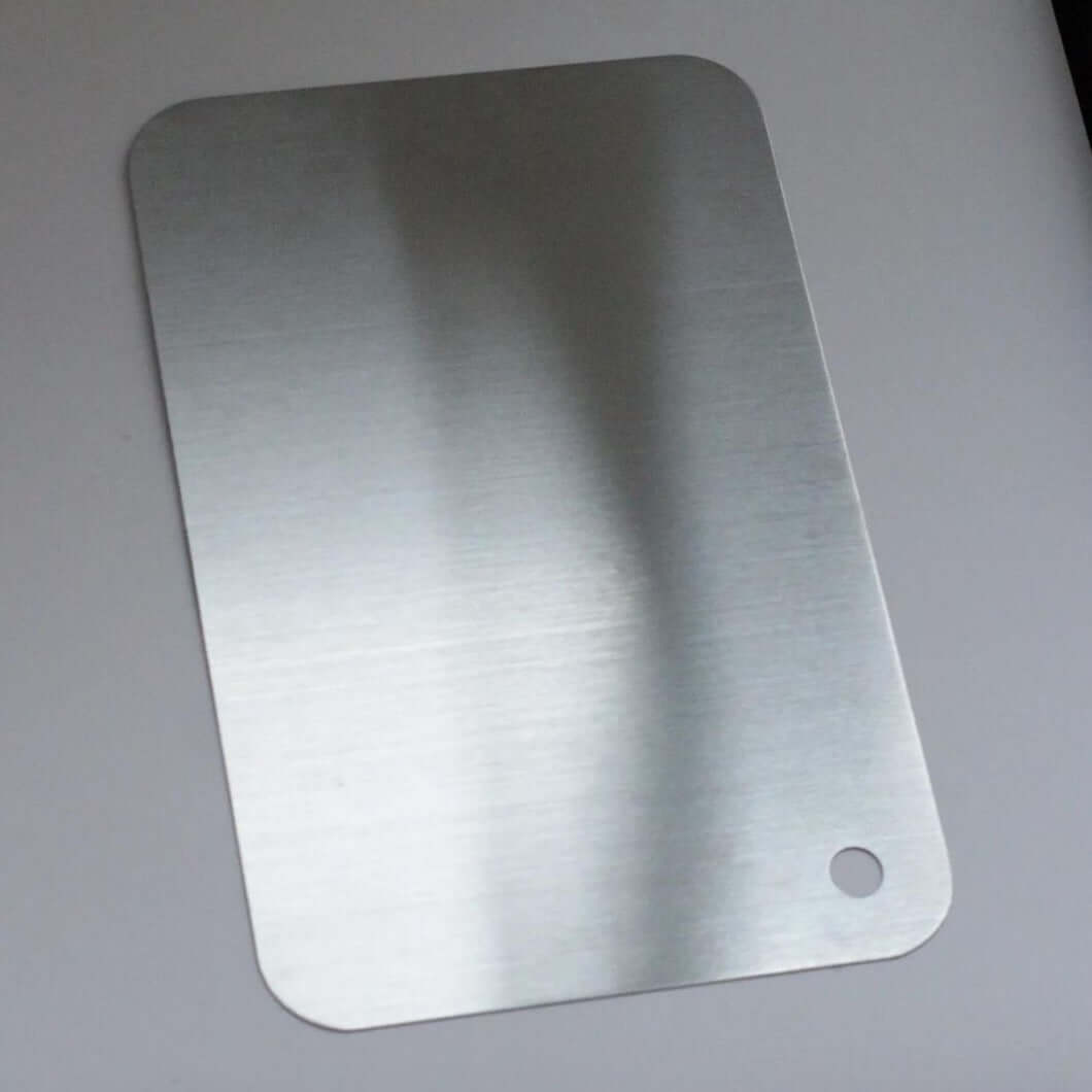 Minimalist SUS 316 stainless steel cutting board with sophisticated design, ideal for serving and display, dishwasher safe.