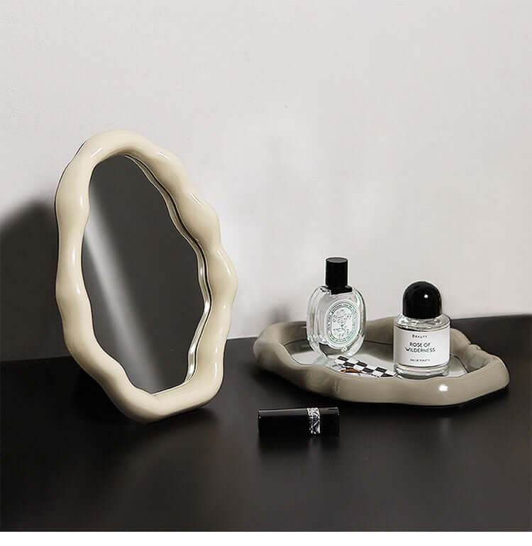 Nordic cloud-shaped vanity mirror with elegant frame on table, featuring perfumes and cosmetics, size 27x20cm.