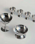 Stainless steel egg holders set of six with an elegant matte finish, perfect for kitchen decor and family breakfasts.