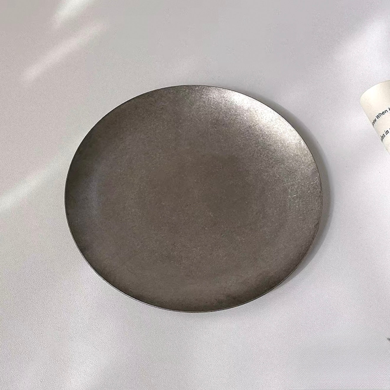 Matte-finished stainless steel Hakone Plate showcasing minimalist design and texture for elegant dining.