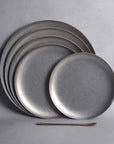 Set of matte-finished stainless steel Hakone Plates in gray tones, showcasing minimalist design for elegant dining.